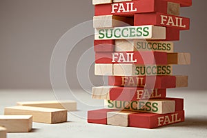 Success and fail. Wooden tower of blocks. Failure is like new step for success. Failure gives experience and makes you successful