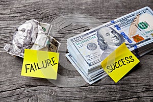 Success and failure in business, choice of ways, concept. Office stickers on dented banknote and pile of dollars