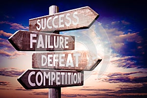 Success, failure, defeat, competition - wooden signpost, roadsign with four arrows