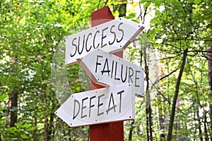 Success, failure, defeat - signpost with three arrows