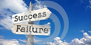 Success and failure - wooden signpost with two arrows