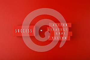 Success formula concept. Vision, goal, strategy, action written on red blocks against red background