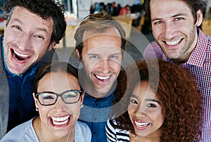 Success is a great feeling. Closeup portrait of a group of estatic coworkers standing in an office.