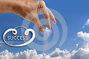 Success hand catching cloud