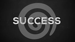 Success handwritten with white chalk on a blackboard