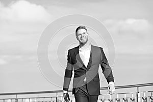 Success his second name. Businessman successful entrepreneur in suit walks outdoor sunny day sky background. Man