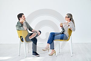 Success is always the main topic of discussion. two businesspeople having a discussion while sitting on chairs in an