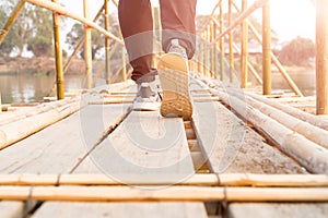 success man walking, traveler man walking to success on the long wooden bamboo bridge