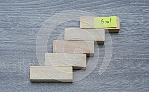 Success in people life concept - step by step to achieve the goals with wood background