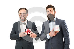 Success and reward. esthete. businessmen in formal suit on party. bearded men hold valentines present. business partners