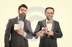 success and reward. esthete. businessmen in formal suit on party. bearded men hold valentines present. business partners