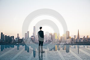 Success and satisfaction concept with businessman back view on rooftop with transparent floor looking on megapolis city