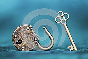 Success, solution, coaching concept, key and padlock on blue background