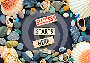 Success starts here symbol. Concept word Success starts here on beautiful wooden block. Sea shell stone. Beautiful black table