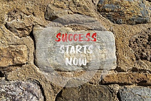 Success starts now symbol. Concept word Success starts now on beautiful big stone. Stone wall. Beautiful stone wall background.