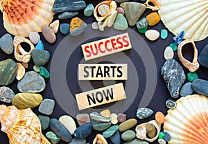 Success starts now symbol. Concept word Success starts now on beautiful wooden block. Sea shell stone. Beautiful black table