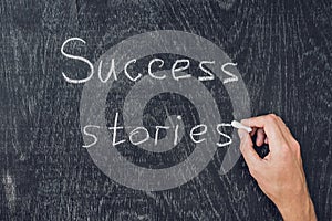 Success stories written on the blackboard using chalk