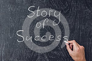 Success stories written on the blackboard using chalk