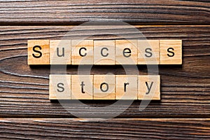 Success story word written on wood block. Success story text on table, concept