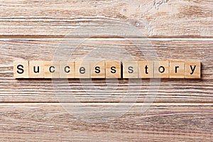 Success story word written on wood block. Success story text on table, concept