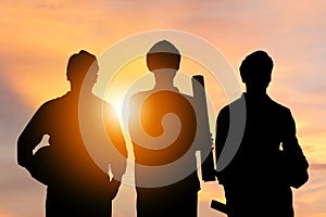 Success and Teamwork Concept, Silhouette of engineer and worker team with clipping path standing with sunset background