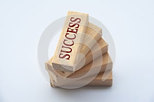 Success text on top of wooden blocks with white cover background. Success concept.