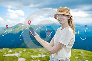 Success tourist woman searching right direction on smartphone on top of mountain with nature background. Mountain