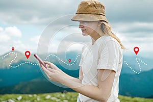 Success tourist woman searching right direction on smartphone on top of mountain with nature background. Mountain