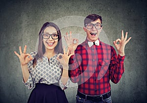 Young funny couple showig ok sign expressing excitement photo