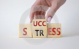 Success vs Stress symbol. Businessman hand turns wooden cubes and changes the word Stress to Success. Beautiful white background.