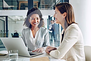 Success will be ours together. Portrait of a corporate businesswoman working with a colleague in an office.