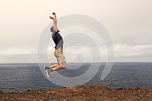 Success or win concept - joyful man jumping