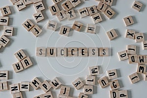 Success written in wooden letter tiles on a white background