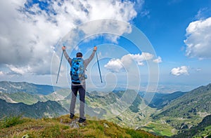 Successful active man hiker on top of mountain enjoying the view. Travel sport lifestyle concept