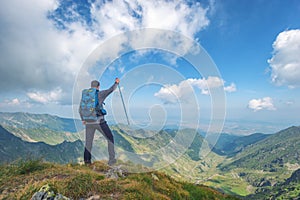 Successful active man hiker on top of mountain enjoying the view. Travel sport lifestyle concept