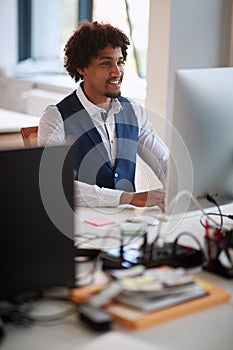 Successful african american businessman working on computer.Modern high tech office