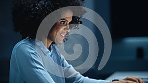 Successful African American Businesswoman Working on Laptop Computer in Big City Office Late in th