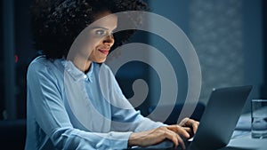 Successful African American Businesswoman Working on Laptop Computer in Big City Office Late in th