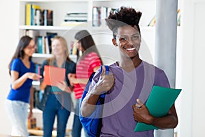 Successful african american male student with group of multi ethnic college students