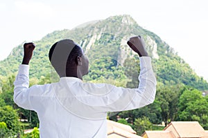 Successful African business man with big mountain in background