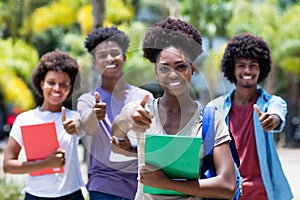 Successful african female student with group of african american students