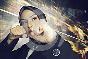 Successful and aggressive young muslimah businesswomen over abstract double exposure background