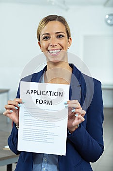 Successful applicant holding up her application form