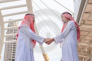 Successful Arabic business people shaking hands