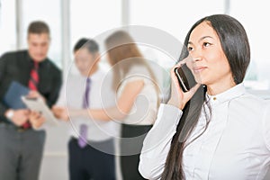 Successful asian business woman using mobile phone