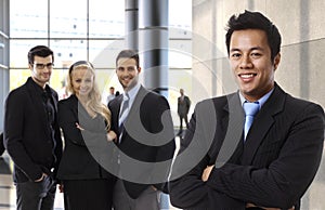 Successful asian businessman leading business team