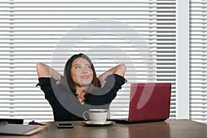 Successful Asian Chinese business woman working confident at modern office computer desk in female businesswoman job smiling chee