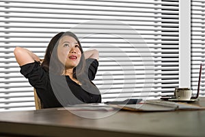 Successful Asian Chinese business woman working confident at modern office computer desk in female businesswoman job smiling chee