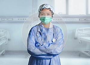 Successful Asian Chinese medicine doctor woman in hospital scrubs and mask posing at clinic patient bed in medical health