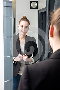 Successful beautiful young woman with winning body language standing